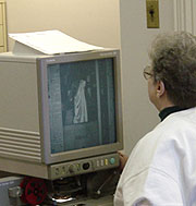 A researcher uses one of our microfilm readers