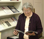 A researcher flips through one of the library's journals