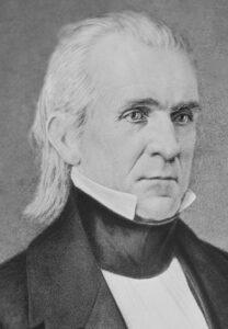 Profile of a man with long white hair and stiff white collar