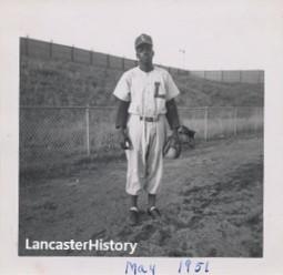 Black and white photo of a Black baseball player