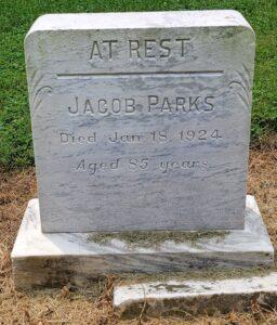 A marble-looking tombstone inscribed for Jacob Parks.