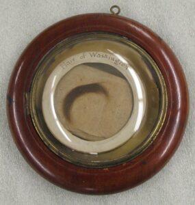 A lock of hair in an oval frame