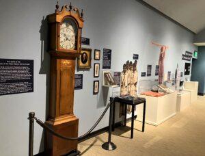 A museum exhibit of objects along a wall