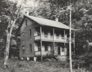 Image of a two story frame cabin on Baker's Island in 1907.