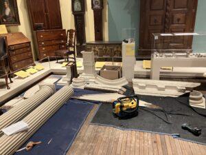 Wooden architectural pieces laid out on a floor