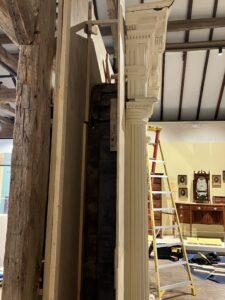 Open cavity showing framing of a wooden doorframe