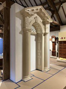 A wooden doorway framed against a wall