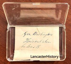 Piece of paper with writing on it in a clear plastic case