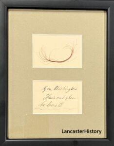 Framed lock of hair and label