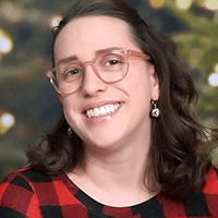 A photo of Sarah Alberico, a young woman with light skin, brown hair, and glasses.