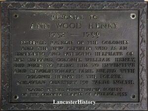 Bronze plaque with raised letters describing contributions of Ann Wood Henry.