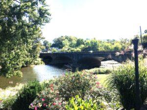 Photograph of a three arch concrete bridge across a river