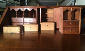 Desk interior showing removal of secret drawers