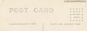 A back of a postcard with a divided back, along with indicators on where to place a stamp, correspondence, and name and address.