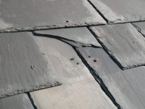 A cracked and partially missing slate on Wheatland's roof.