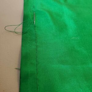 Joining skirts at the center back seam with a back stitch. Note the selvedged (finished) edge,