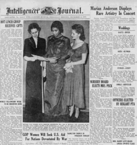 Image of a newspaper clipping from 1947. Two light-skinned women with dark hair and a dark-skinned woman with dark hair stand together looking at a concert program. The title of the article "Marian Anderson Displays Rare Artistry in Concert"