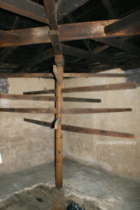 Photograph of the wooden meat tree with metal hooks to hang meat