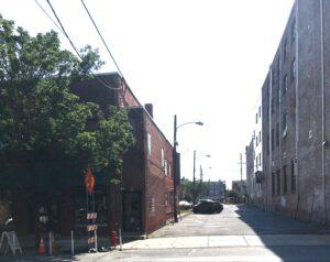 Street scene showing a parking lot between two buildings.