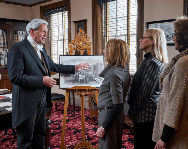 Reenactor gives a tour to guests in Buchanan's library in Wheatland.