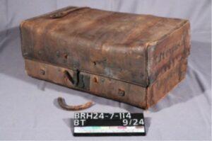 Leather suitcase with some damage and missing handle.