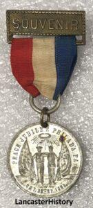 A souvenir medallion with a red, white, and blue ribbon