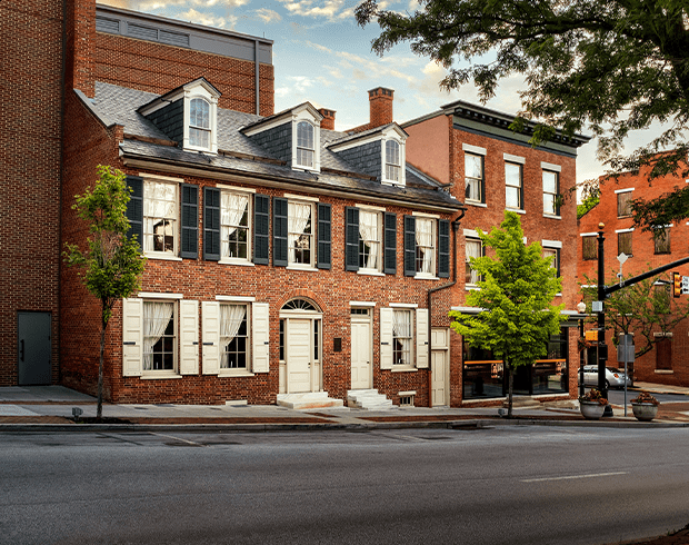 A vibrant contemporary photo of historic brick buildings along a road.