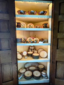 Built in china cupboard containing two different china patterns.