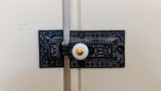 The finished hardware installed onto the painted cabinet doors.