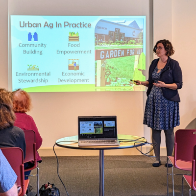 A presenter for the Tanger Arboretum's Nature Series gives a presentation, with PowerPoint, about urban agriculture.