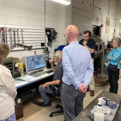 Group of people looking at a computer screen.