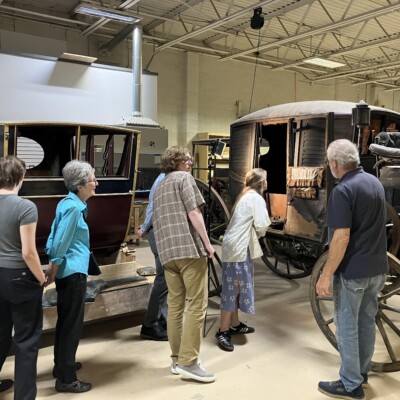 Group of people looking at a carriage.
