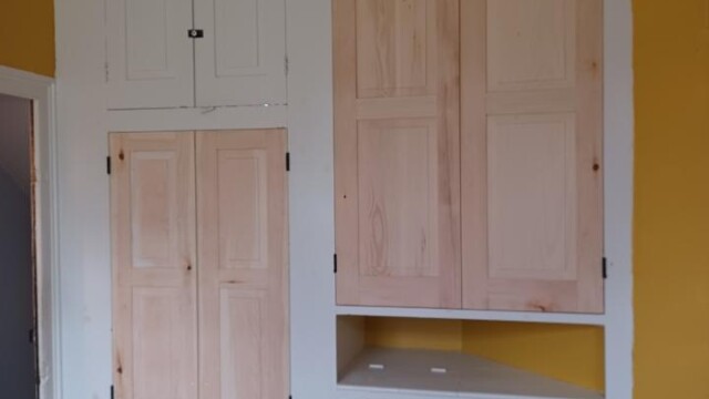 Cabinet doors installed to the dumbwaiter (left) and shelves (right).