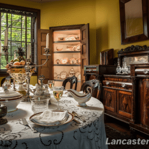 The Dining Room A perspective of the Dining Room with a set dining table and cabinets of china in the background.