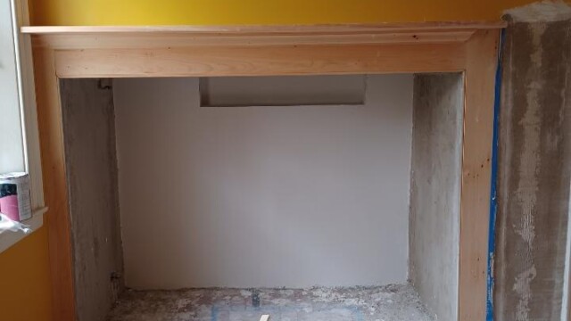 Final layers of plaster being applied to the firebox.