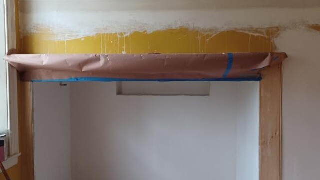 Removed pegboard and plastered wall in preparation for painting.
