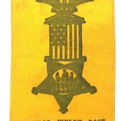 <i> Yellow silk swallowtail ribbon with printed GAR badge in center., National Encampment, Pittsburg(h), 1894. LancasterHistory, Gift of Civil War Museum of Philadelphia. </i> Yellow Ribbon with GAR symbol in center.