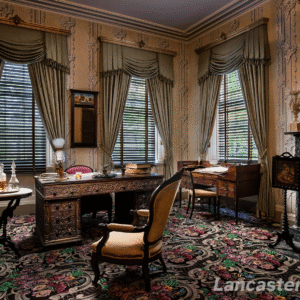 The Sitting Room A perspective view of the sitting room at Wheatland, featuring a colorful carpet with floral designs and, prominently, the president's teakwood desk in the middle.