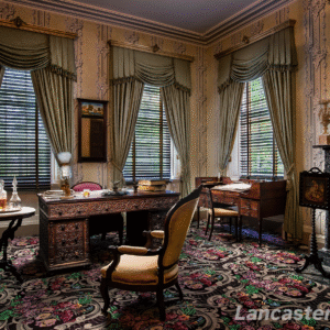 The Sitting Room A perspective view of the sitting room at Wheatland, featuring a colorful carpet with floral designs and, prominently, the president's teakwood desk in the middle.