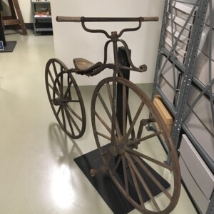 <i>The velocipede after fabrication of the handlebar. Velocipede mount built by Facilities Manager Jim Smith. </i> Velocipede final product on supporting stand.