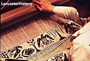 Person weaving on a loom.