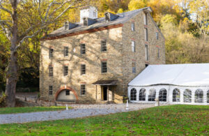 Image of Historic Sickman's Mill with adjoining tent.